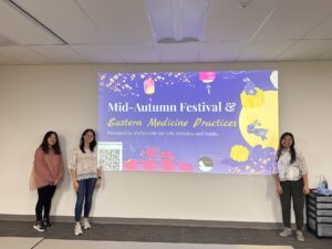 Picture of Van Anh Le, Veronica Chen, and Natalie Feider in front of their slideshow deck