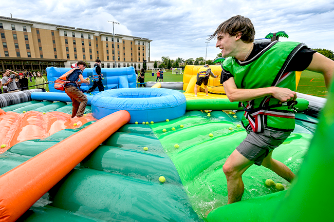 Undergraduate students throw tennis balls during a fierce (and wet!) round of inflatable hungry hippo during the Block Party at the Bakke Recreation & Wellbeing Center. (Photo by Althea Dotzour / UW–Madison)