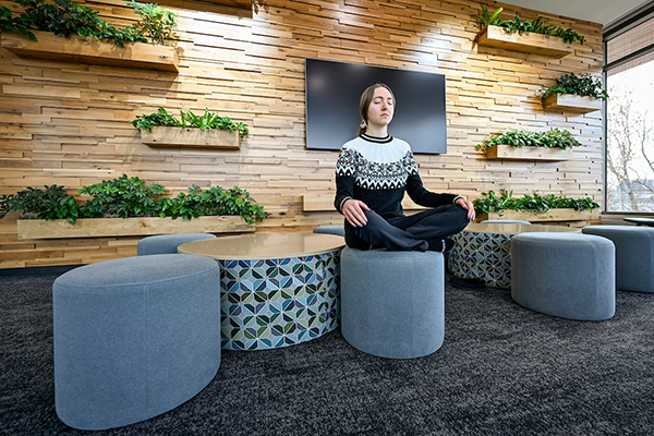 A RecWell wellbeing professional intern pauses for a mindful moment in the Willow Room at the Bakke Recreation and Wellbeing Center at the UW–Madison (Photo by Althea Dotzour / UW–Madison)