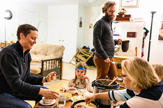 A grad student family gathers for dinner in their Eagle Heights apartment