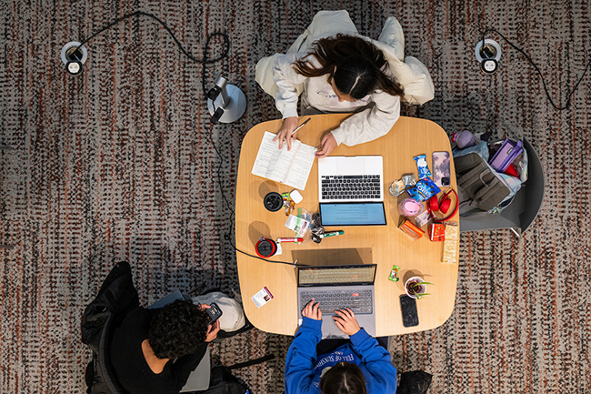 Bird's eye view of 3 students studying together in Morgridge Center
