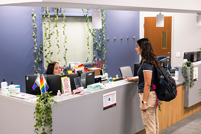 A student checks in at the Student Health Clinic desk