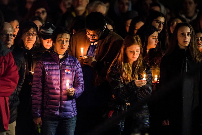 Students gather for an interfaith candlelight vigil near central campus