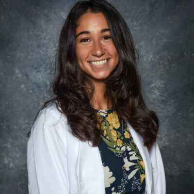 portrait of Nourhan El-Sanjak in her white pharmacy coat